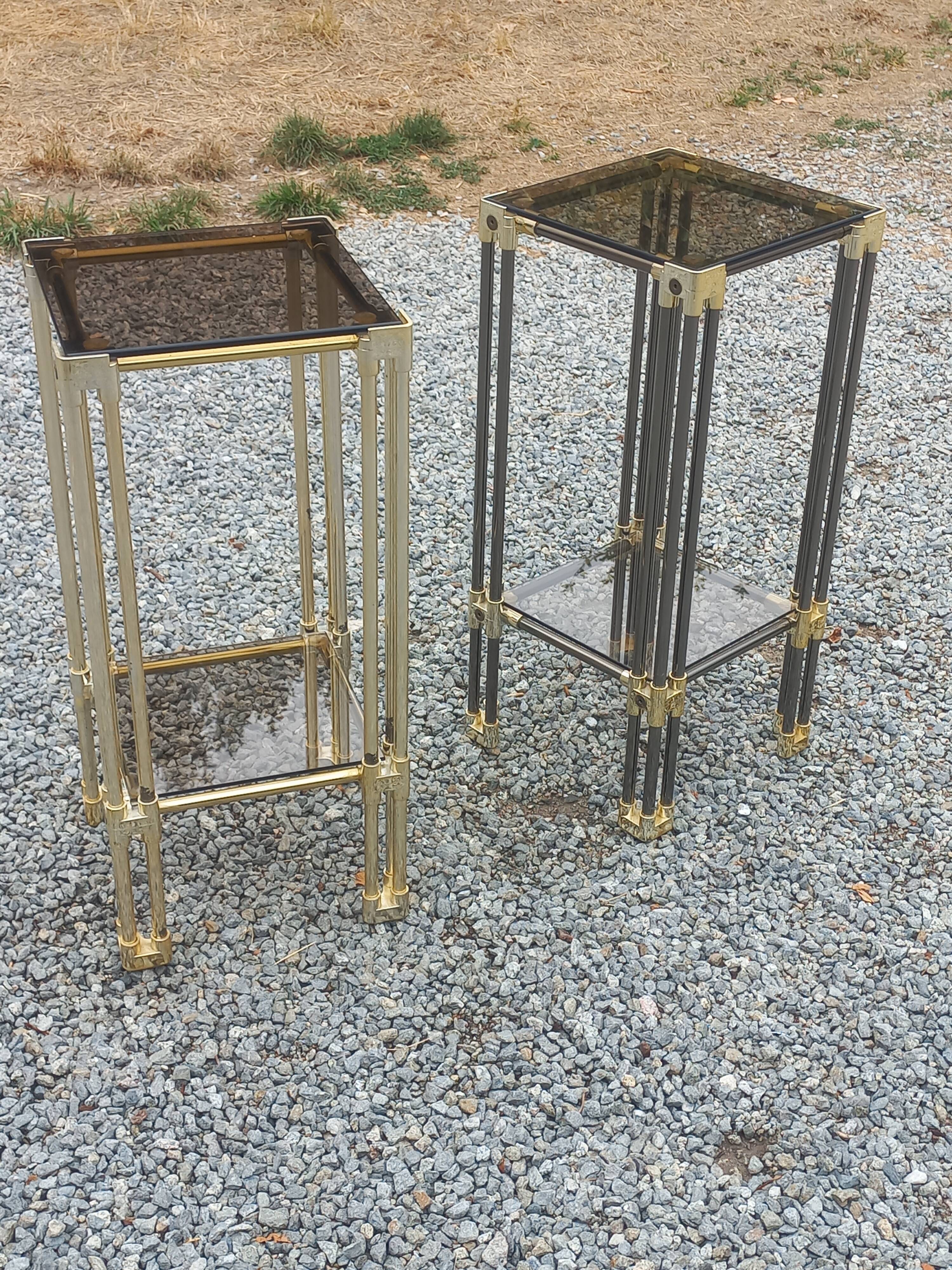 Pair of Hollywood Regency side tables in gold metal and smoked glass.
