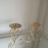 Two beige iron candle holders in a heart shape