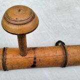 Old rustic wooden coat rack turned in imitation of bamboo
