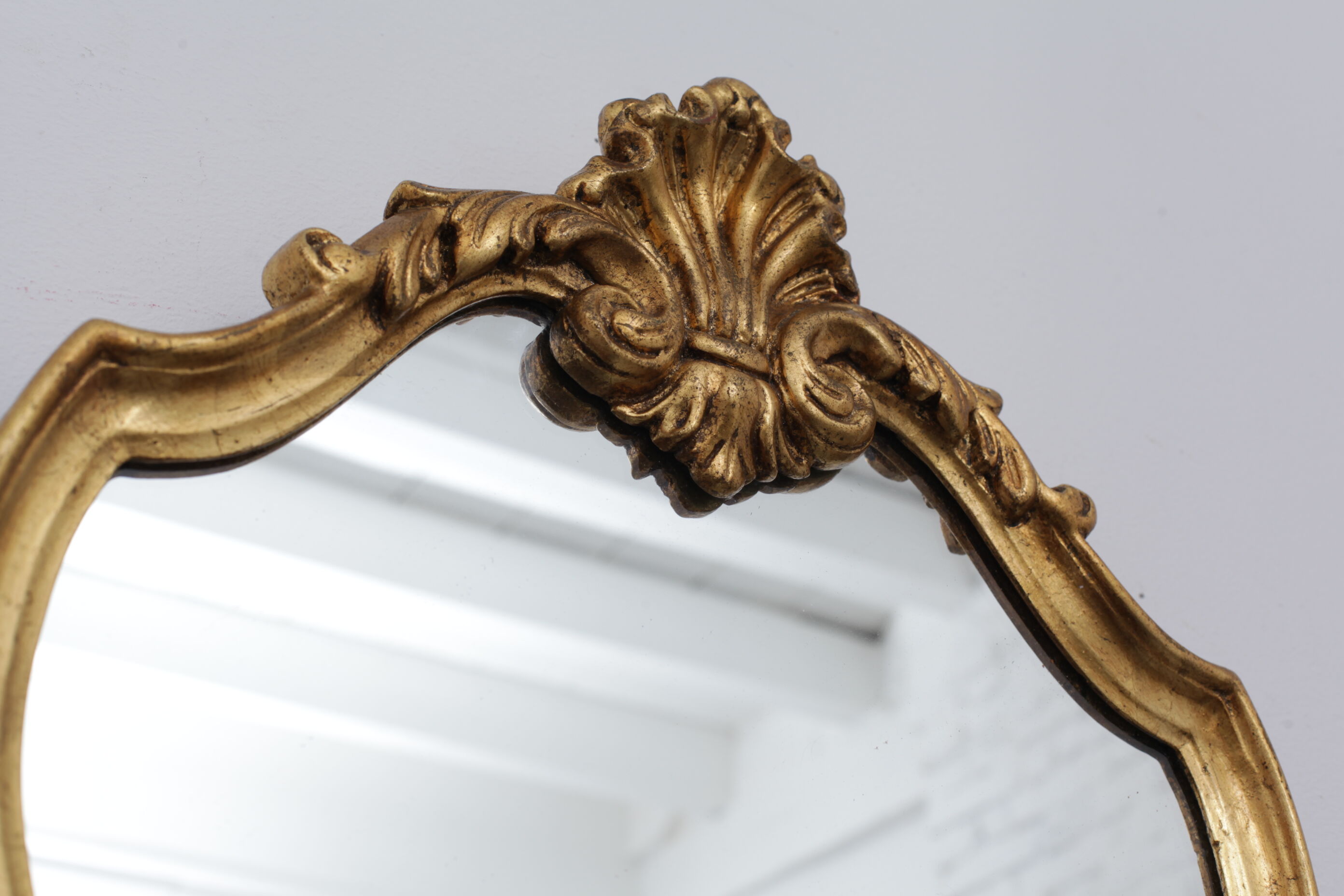 Golden rococo mirror with gold leaf