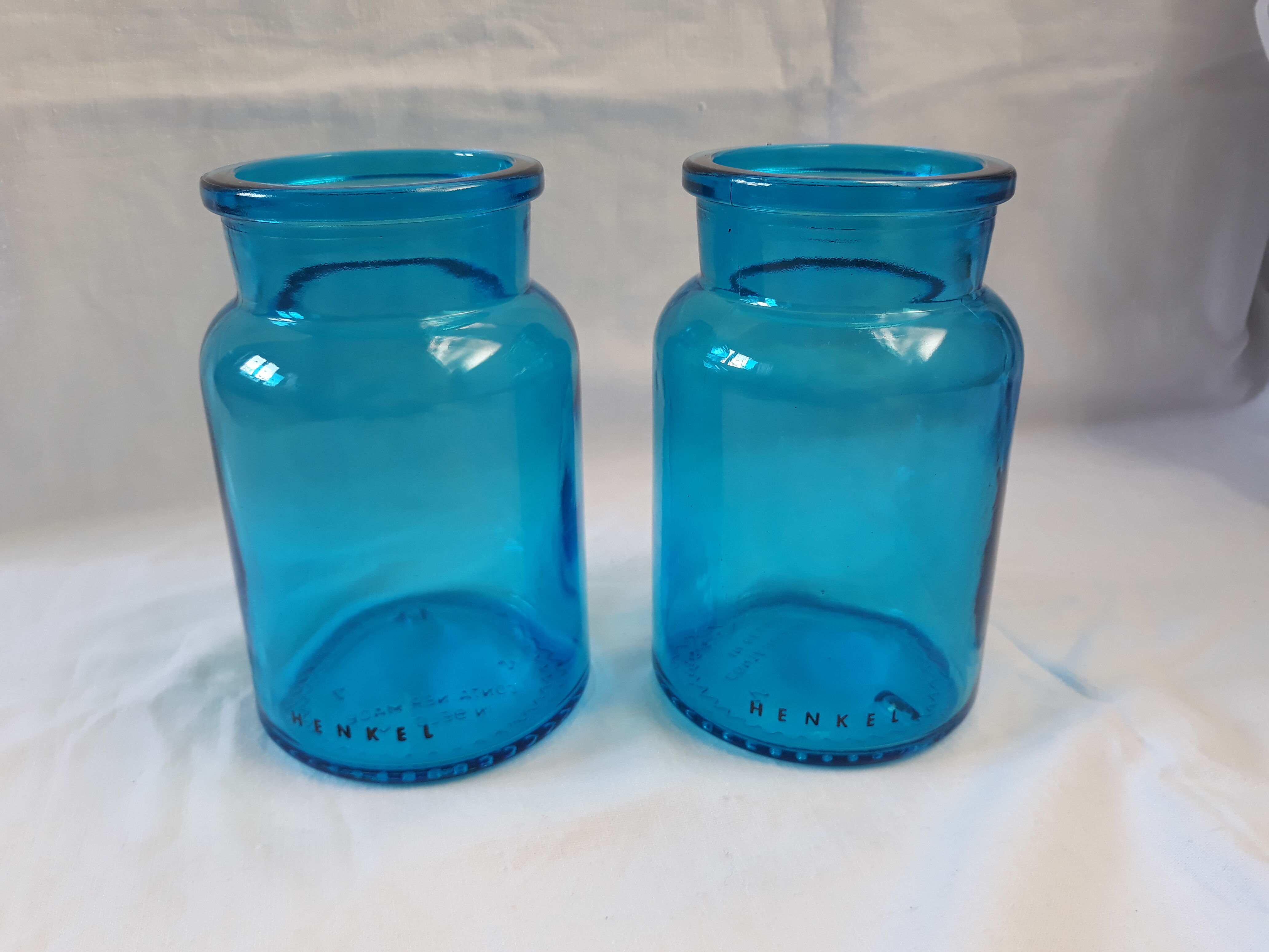 pair of apothecary vials in blue glass jar