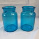 pair of apothecary vials in blue glass jar