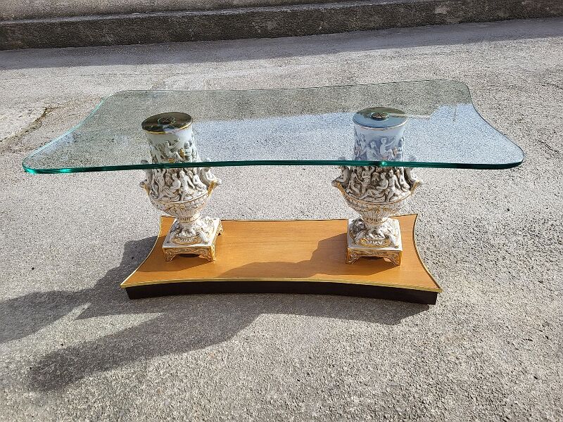 Italian coffee table with glass top, wooden base, and porcelain legs