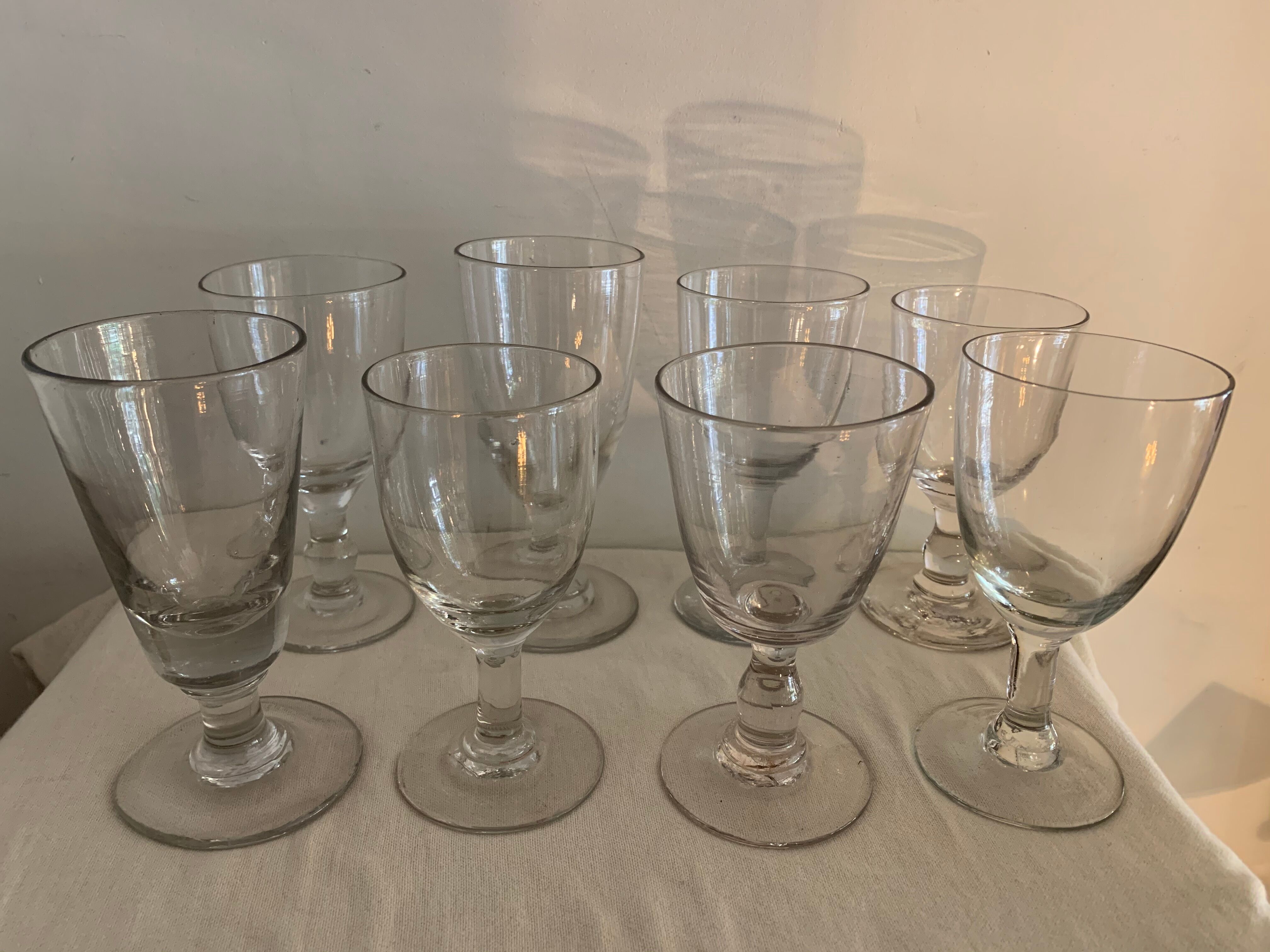8 old blown and different foot wine glasses