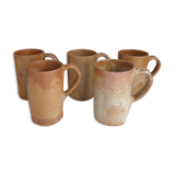 Suite of five sandstone mugs