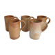 Suite of five sandstone mugs