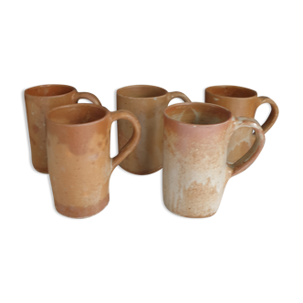 Suite of five sandstone mugs
