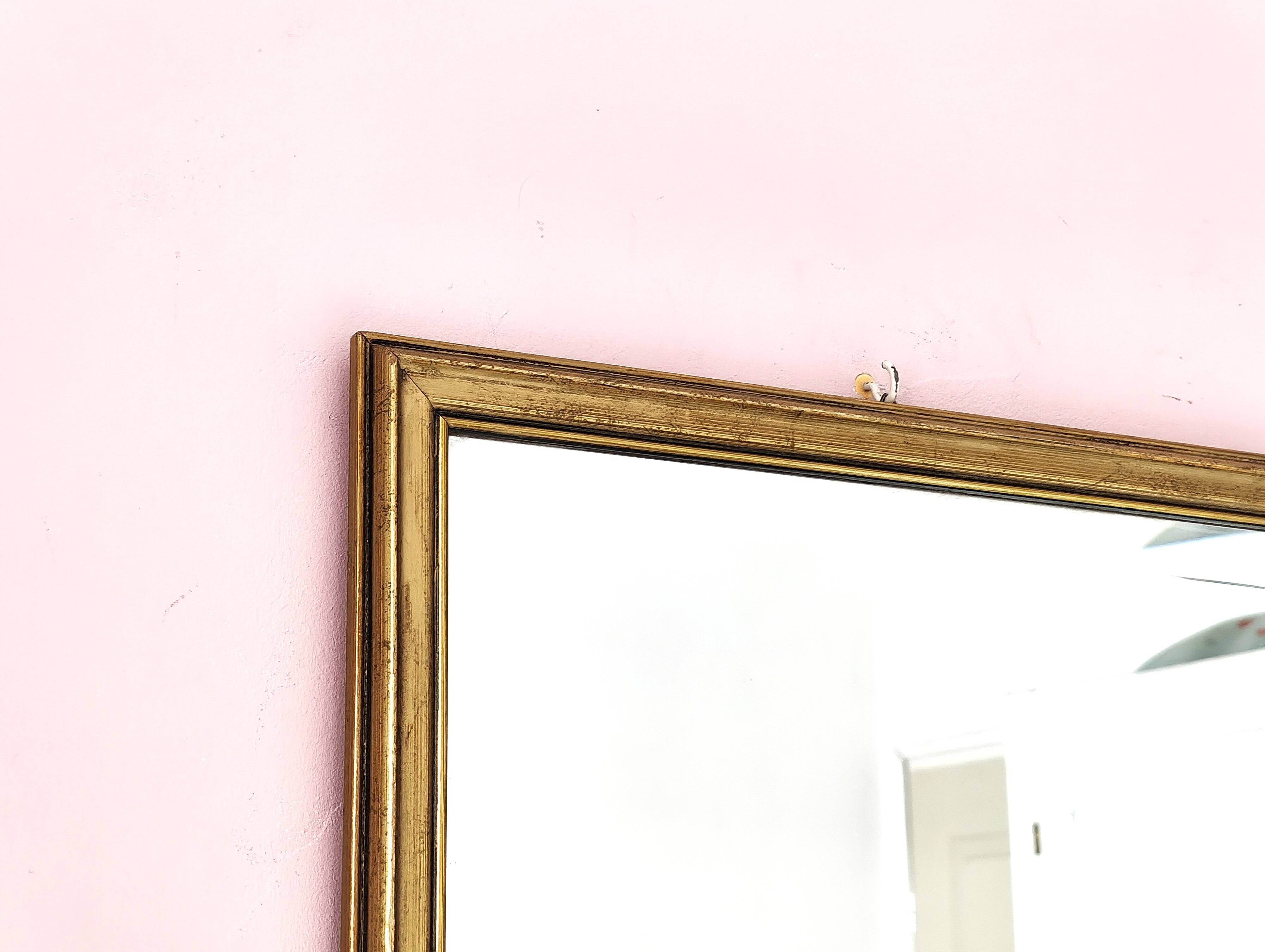 Rectangular gold mirror with bevelled glass.
