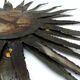 Large brutalist sun mirror in patinated metal with gold accents, 1970.