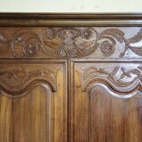Louis XV period wardrobe façade, solid wood architectural elements, richly carved.
