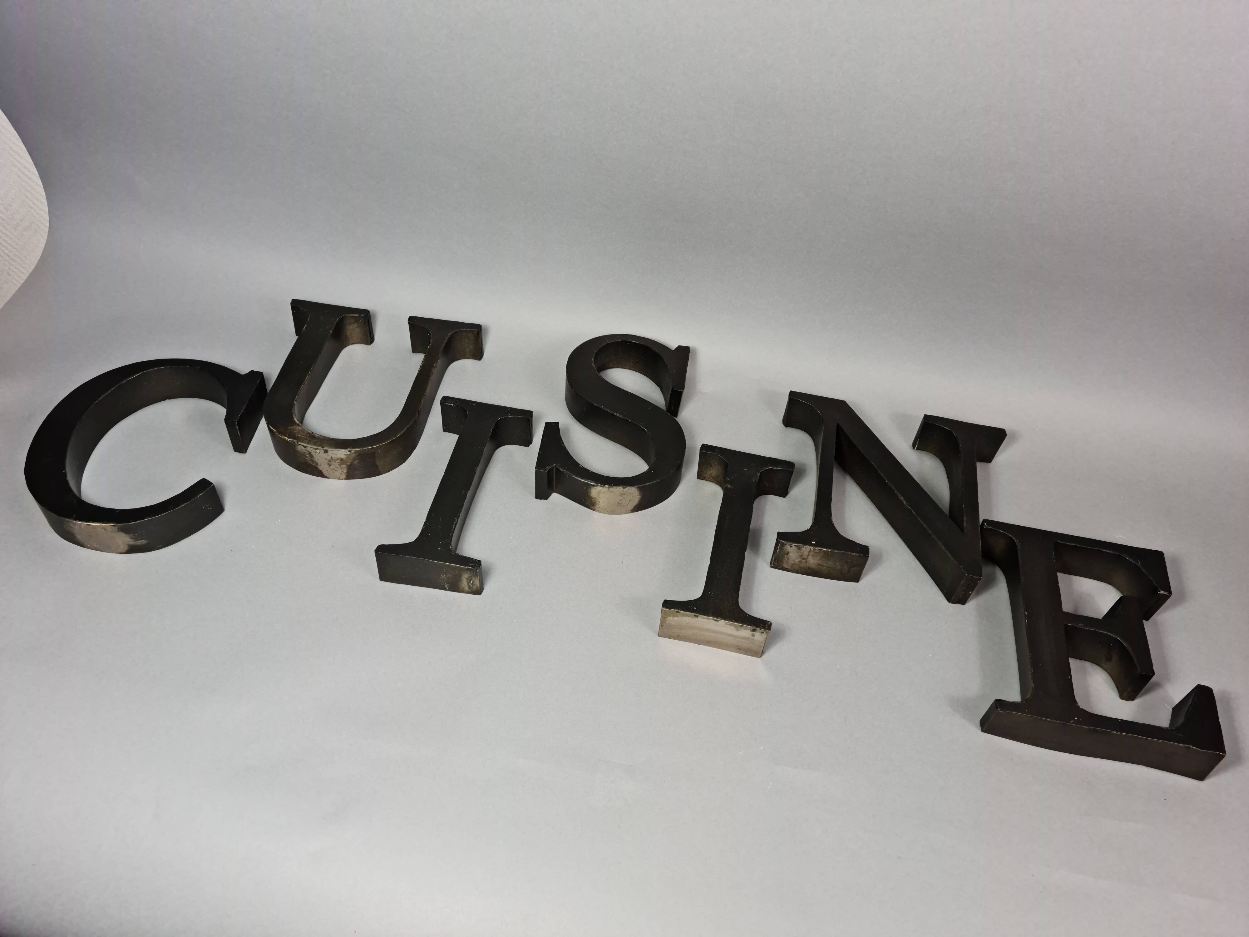 "kitchen" lettering set in blackened metal