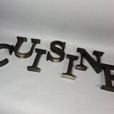 "kitchen" lettering set in blackened metal