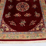 China wool fringed rug with floral pattern on deep plum background 393x274cm
