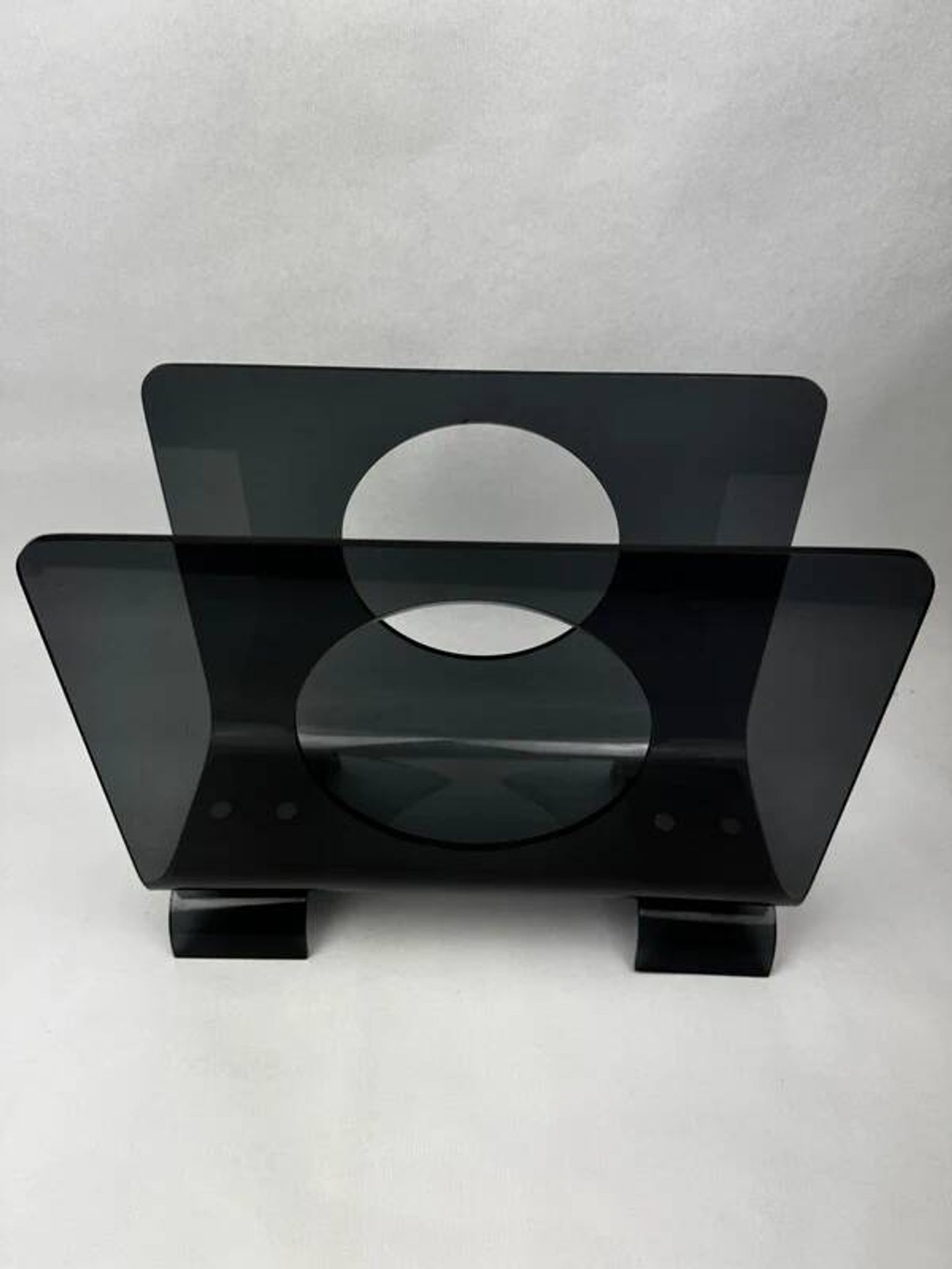Vintage 1970s smoked plexiglass magazine rack, minimalist design.