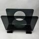 Vintage 1970s smoked plexiglass magazine rack, minimalist design.