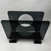 Vintage 1970s smoked plexiglass magazine rack, minimalist design.