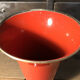 Cut vase on foot in red and black metal