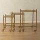 Set of 3 vintage Hollywood Regency nesting tables with brass frame and glass tops (1960s)