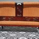 Old bench in wood and orange velvet