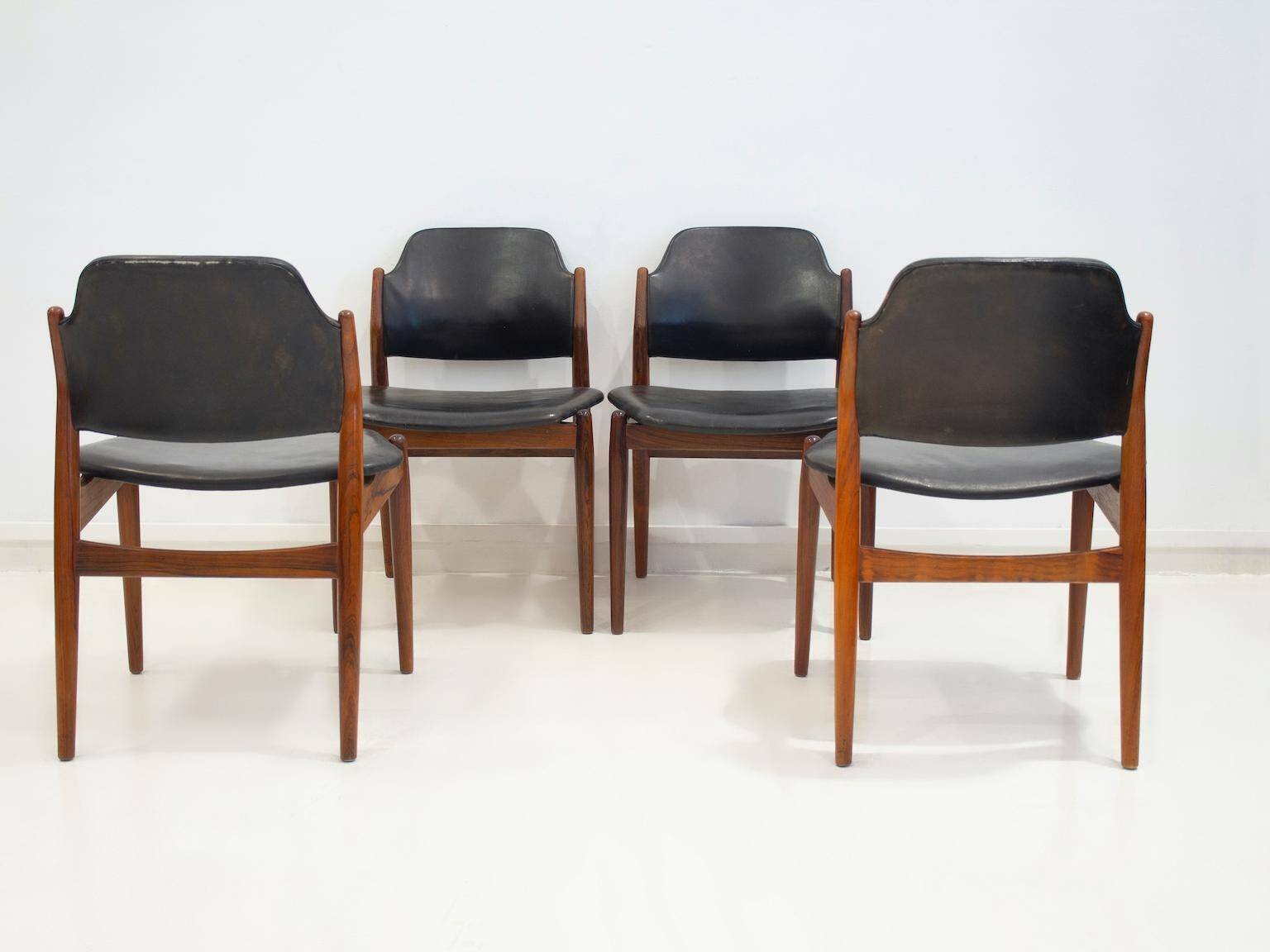 Set of four Arne Vodder chairs in hardwood and black leather.