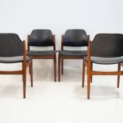 Set of four Arne Vodder chairs in hardwood and black leather.