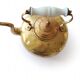 Victorian tripod kettle made of brass with a porcelain handle.