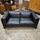 Two-seater sofa in black leather, designed by Tito Agnoli for Poltrona Frau, Italy, 1980s