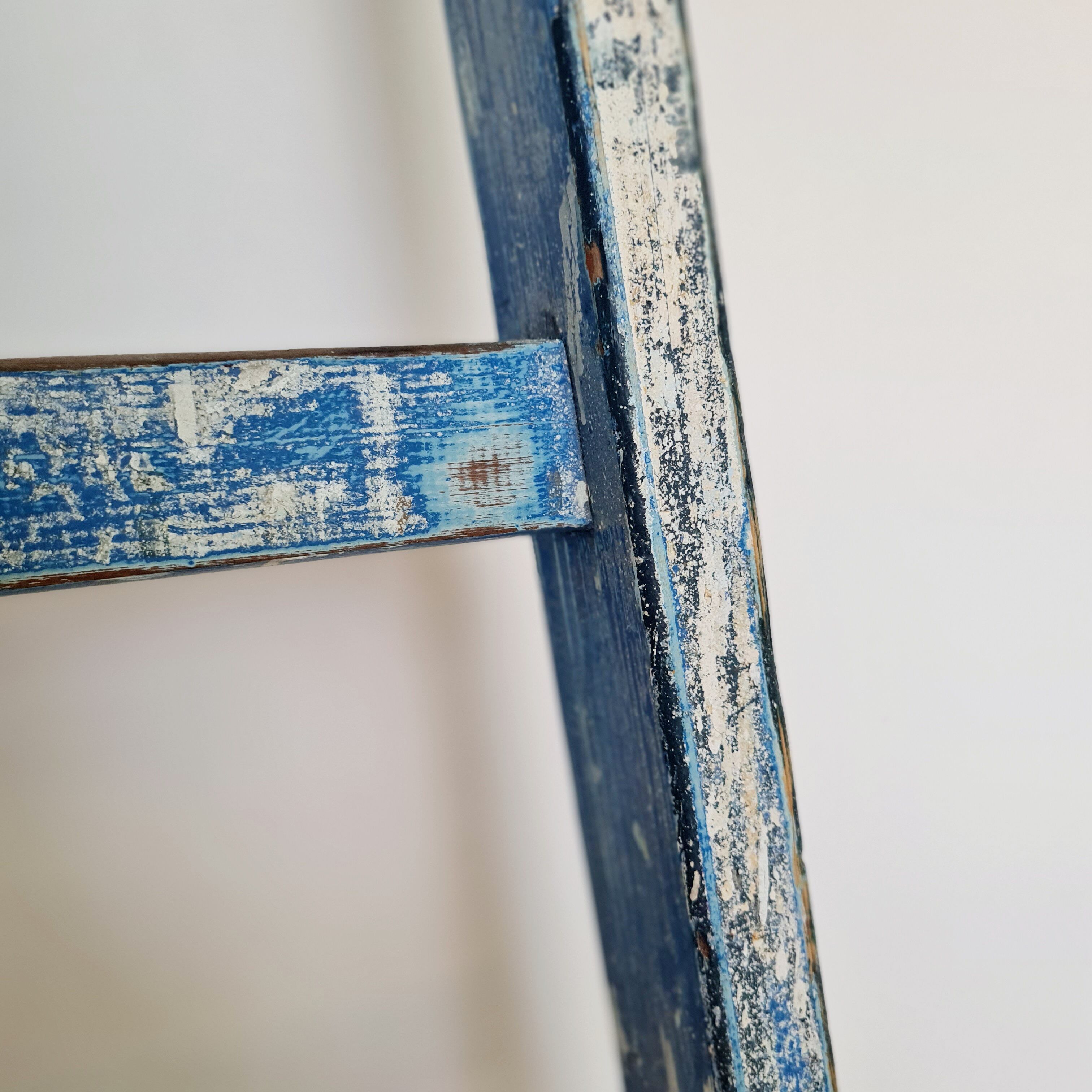 Old ladder in blue wood