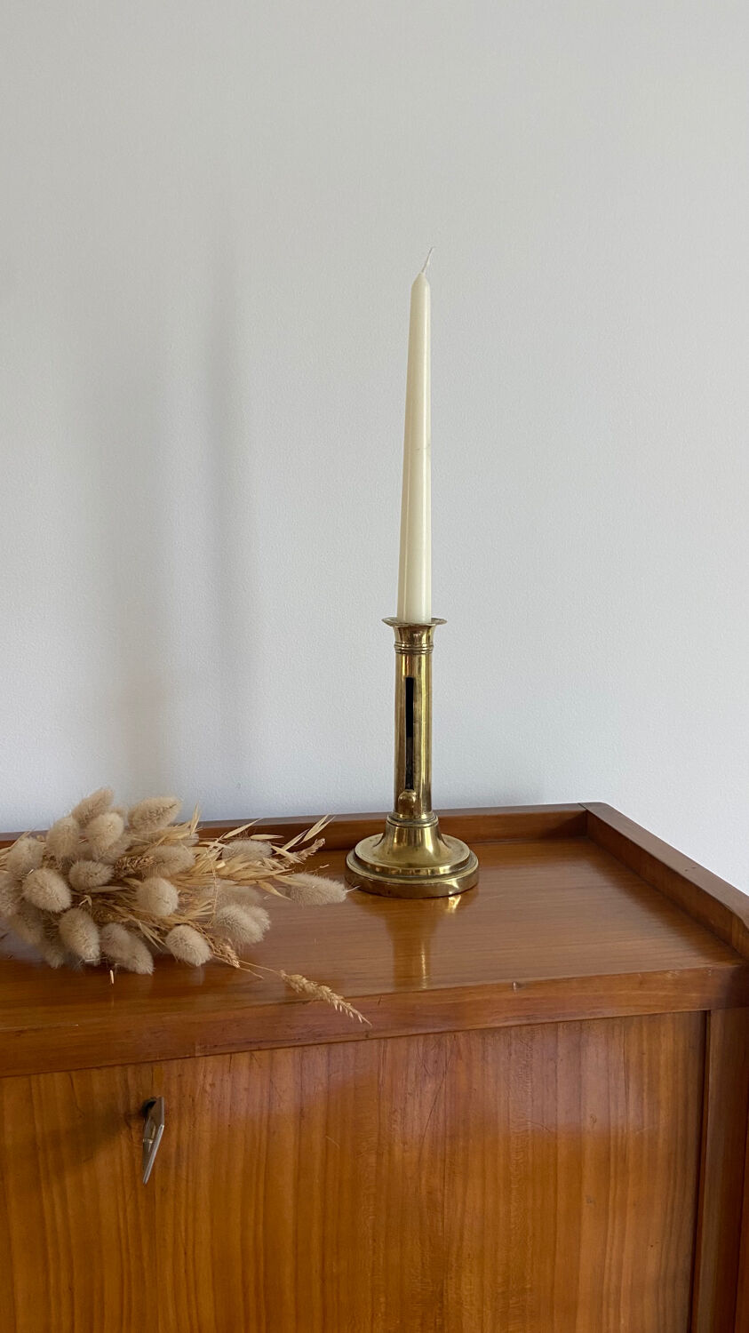Old brass push candle holder