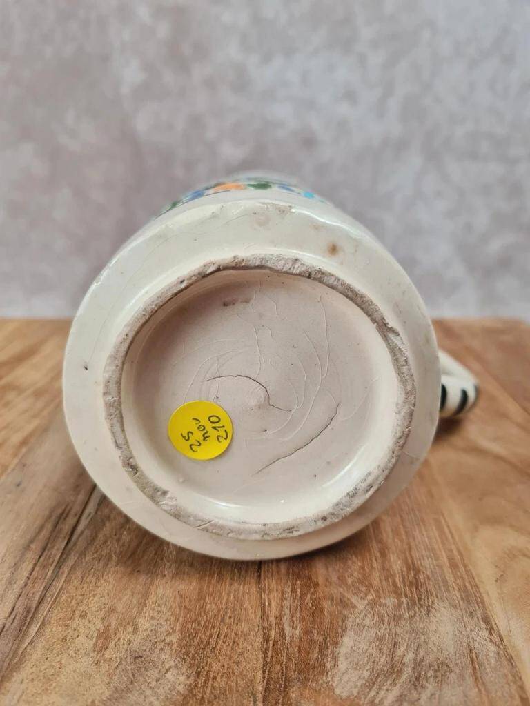 Old pitcher in Tunisian earthenware with colourful decoration.