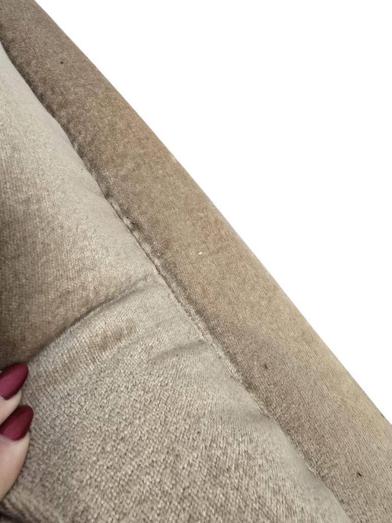 Vintage beige two-seater canapé with fringes.