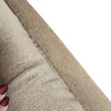 Vintage beige two-seater canapé with fringes.