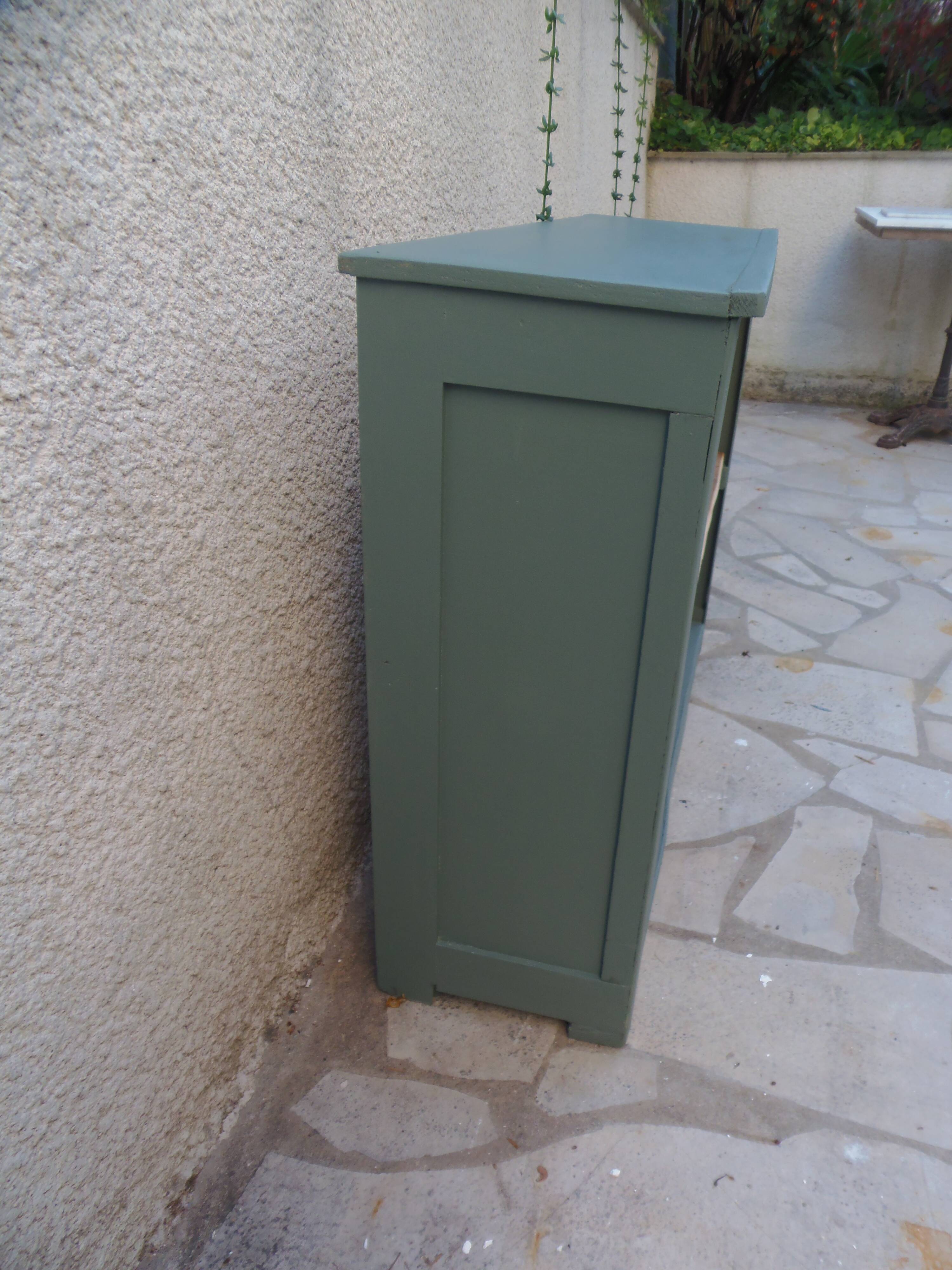 Vintage workshop furniture transformed into a re-enchanted bookshelf in smoky green.