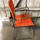 Fauteuil pliant tube métal noir avec tissu orange années 70 vintage