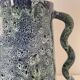 Blue-green ceramic vase with abstract wavy handles
