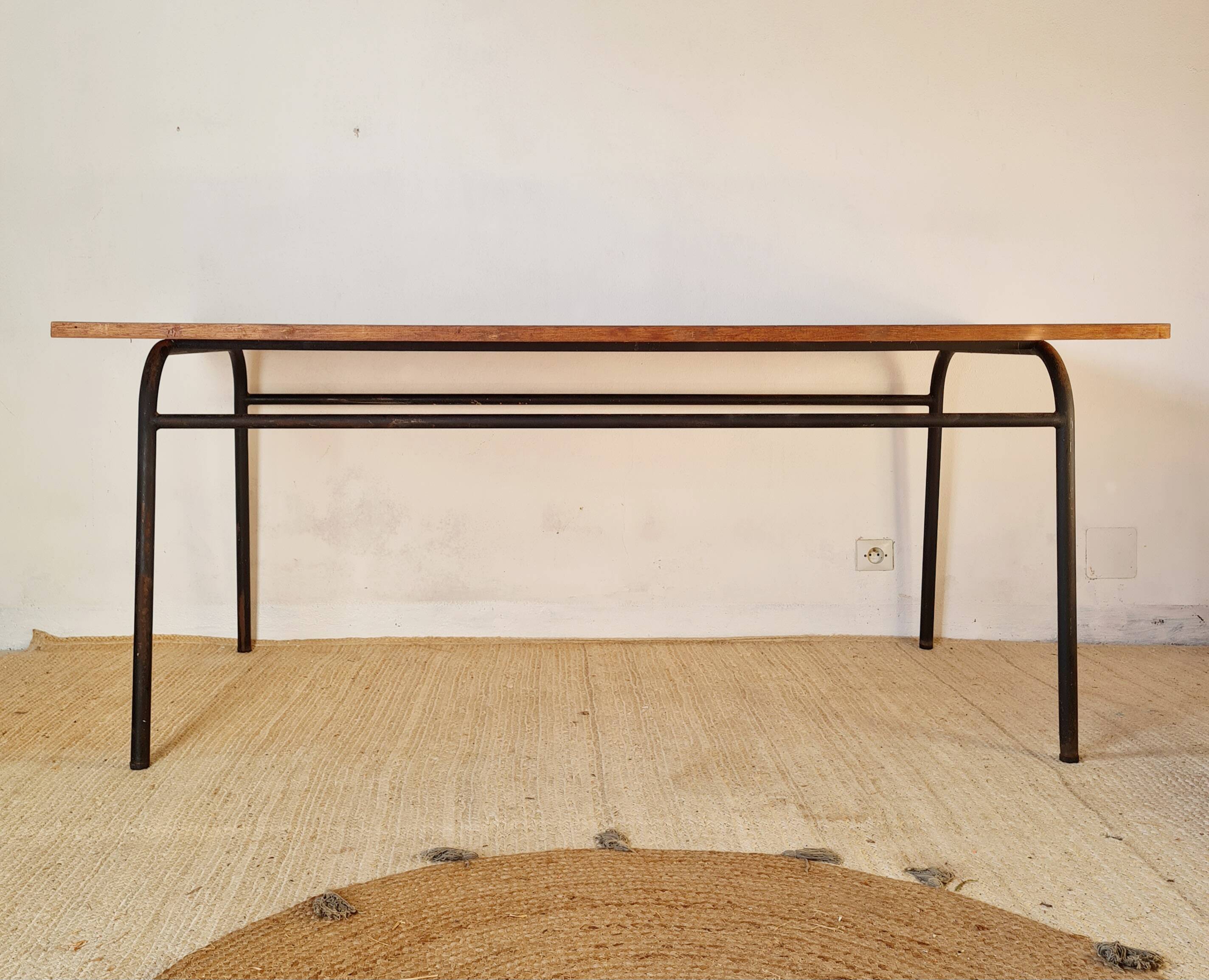 Metal tubular base table with a wooden top.