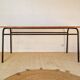 Metal tubular leg table with a wooden top.