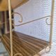 Wall shelf in metal with slanted shelves