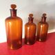 3 old pharmacy vials