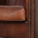 Characterful sheepskin club armchair in a dark cognac colour in English style
