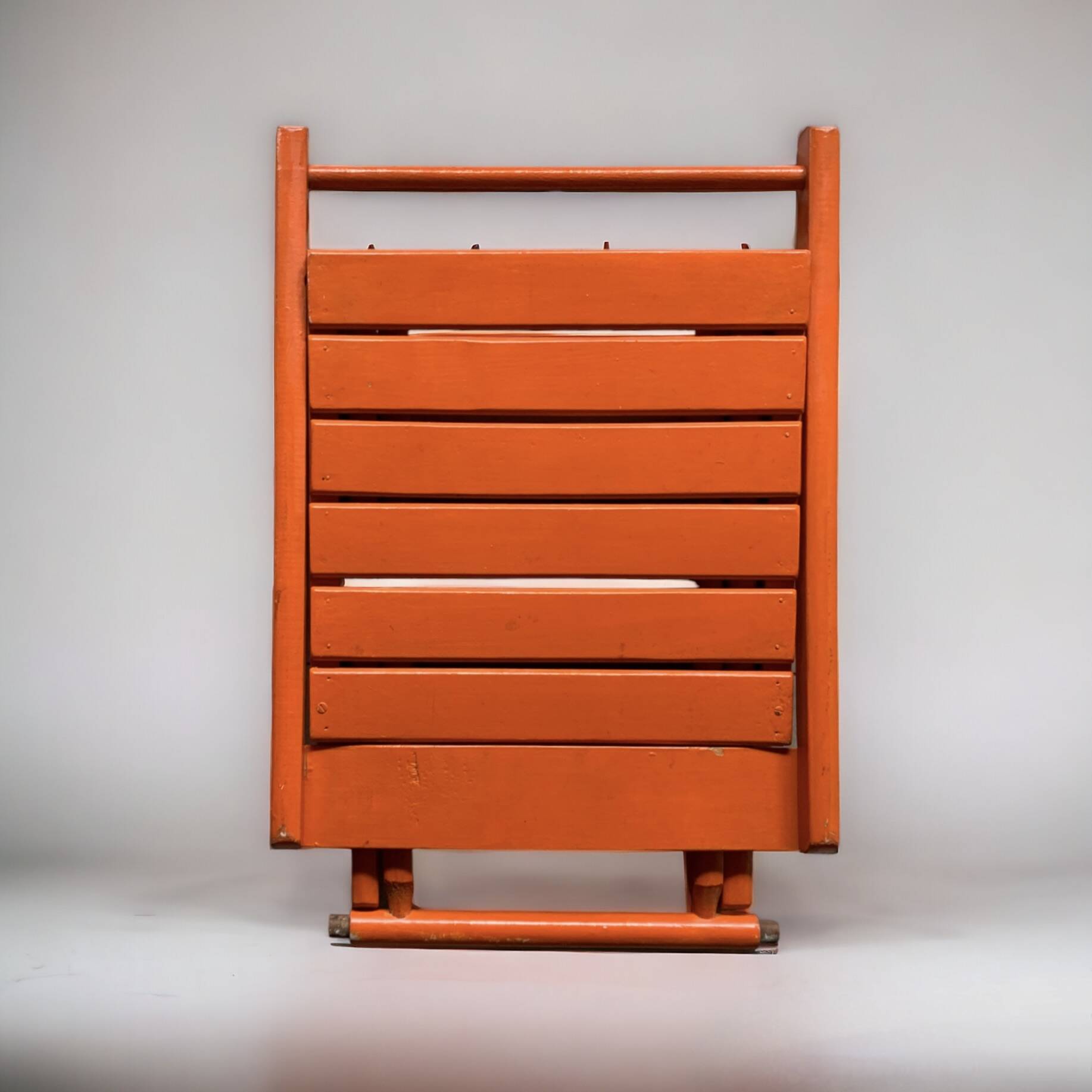 Vintage folding chair in orange painted wood