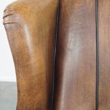 Sheep leather wingback chair finished with black piping