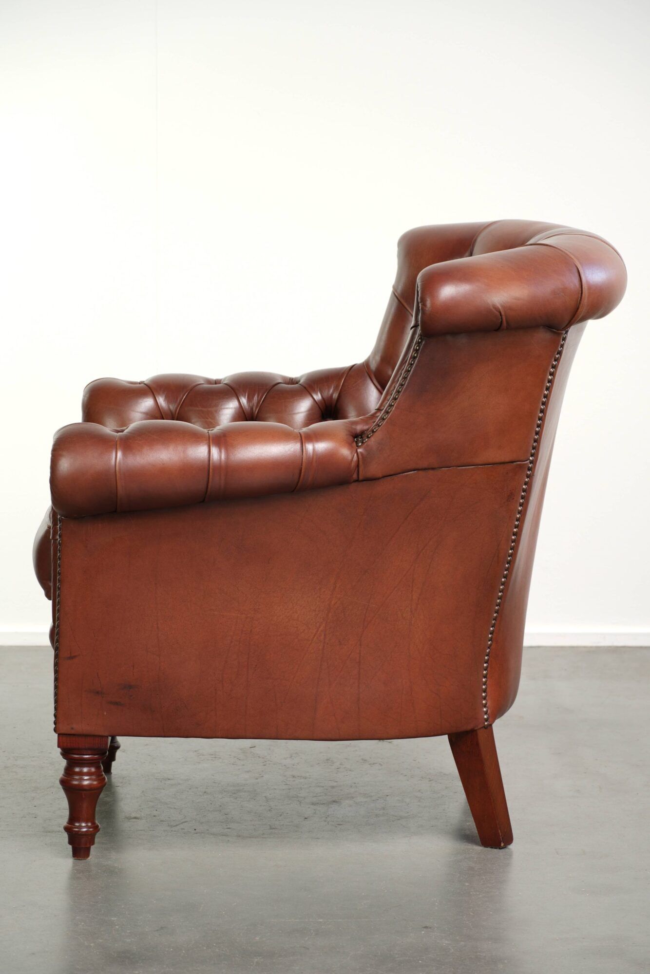 Cognac-coloured cow leather Chesterfield armchair in English style