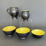 Two pitchers and three Elchinger ceramic bowls black and yellow background 1960
