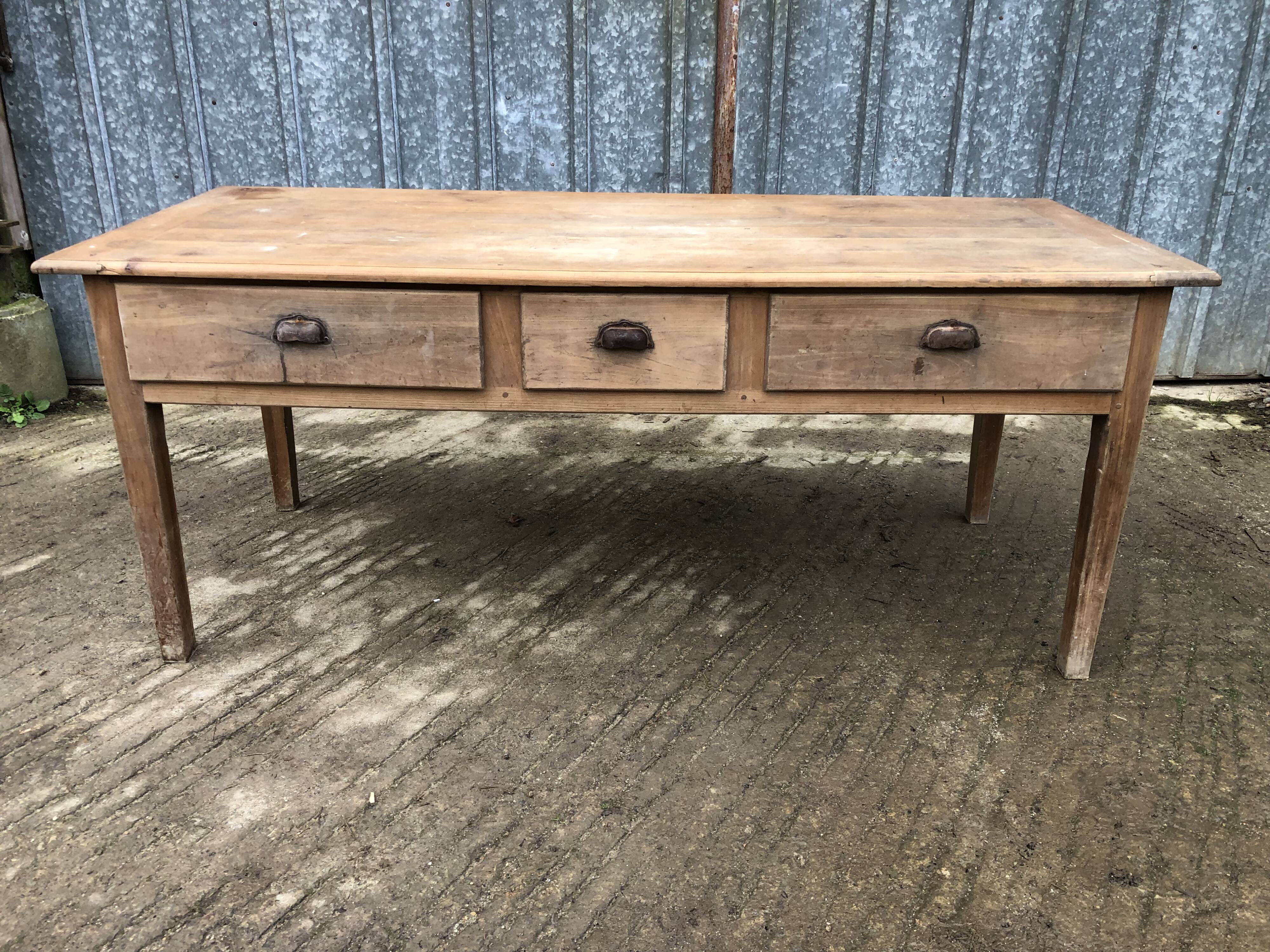 Antique solid cherry farm table with 3 front drawers.