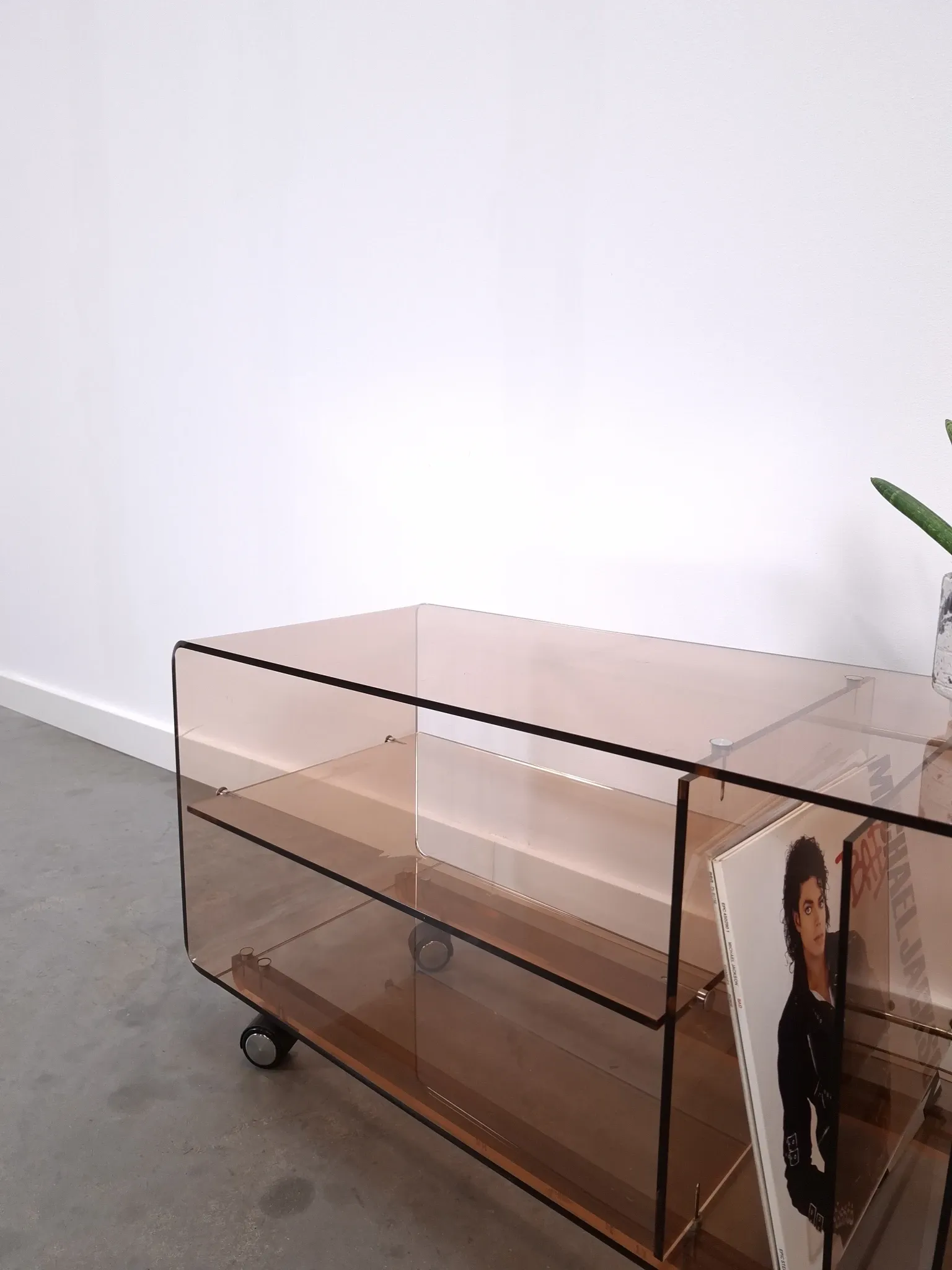 Vintage hifi, LP cabinet, TV unit made of tinted plexiglass on wheels, records.