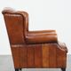 Sheepskin wingback armchair with stitching and black piping