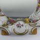 Antique porcelain mirror from Dresden with relief flowers and rococo decoration.
