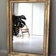 Wood and gilded stucco mirror, 19th century, 115 x 61.5 cm.