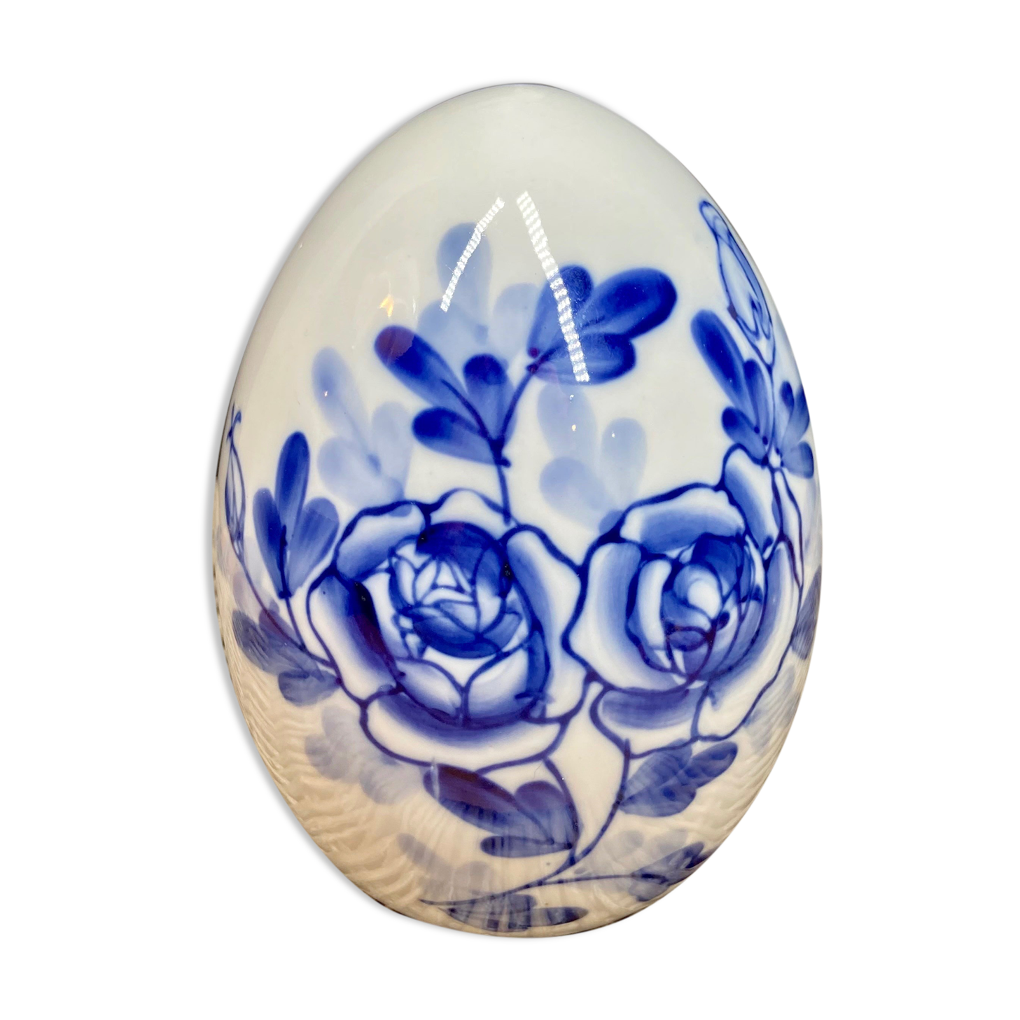 Decorative egg in white porcelain decoration blue flowers